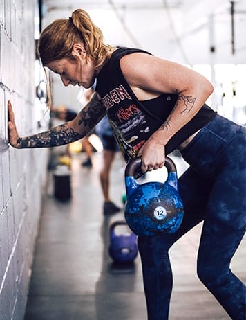 woman training with a kettlebell at Delta Train